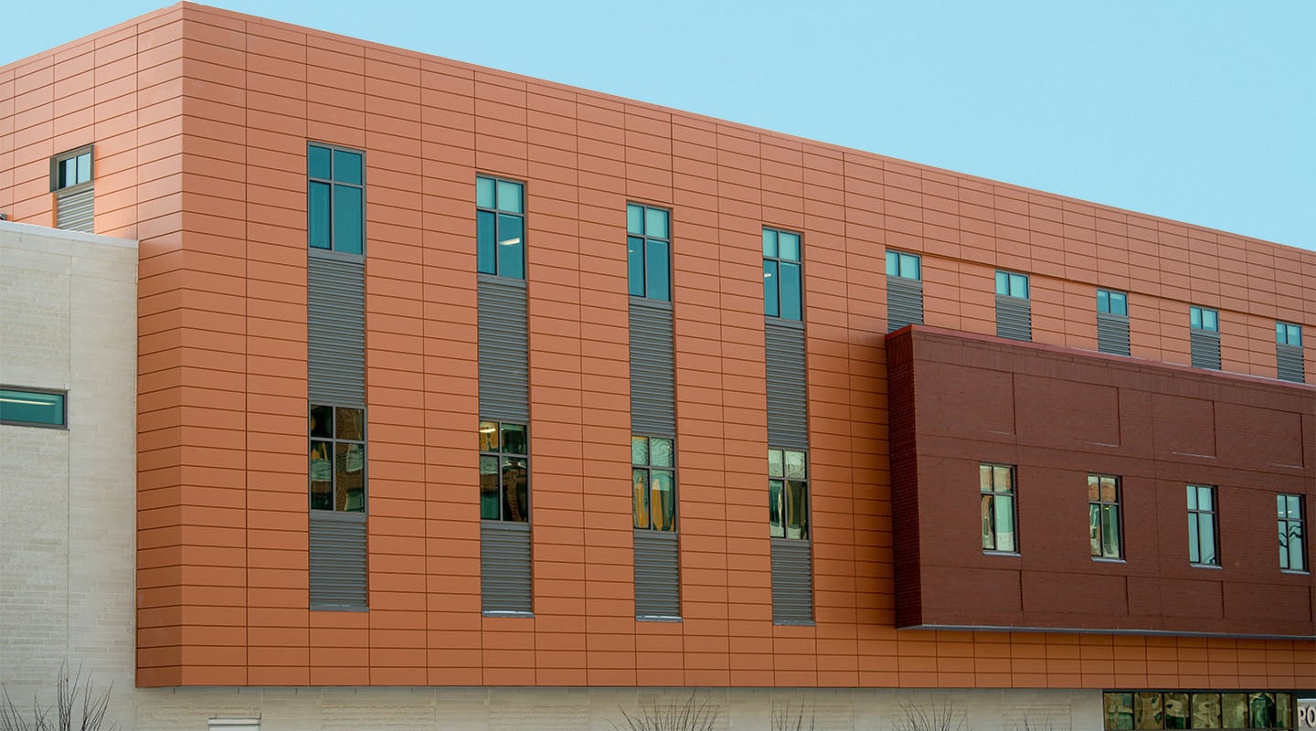 side of building with orange and brown panels